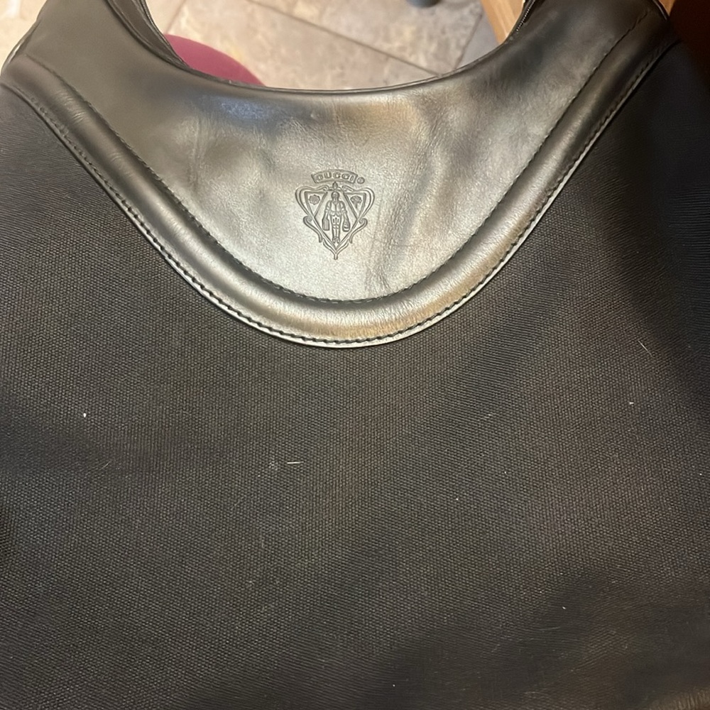 Black Gucci hand bag dims 15 in wide 10 in long on short end 13 in on long.